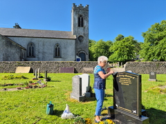 Tending her brother's grave